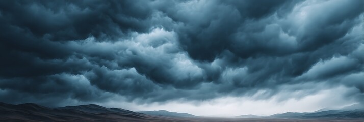 Obraz premium A dramatic landscape featuring dark, swirling clouds looming over a distant horizon, evoking a sense of foreboding and power in nature.