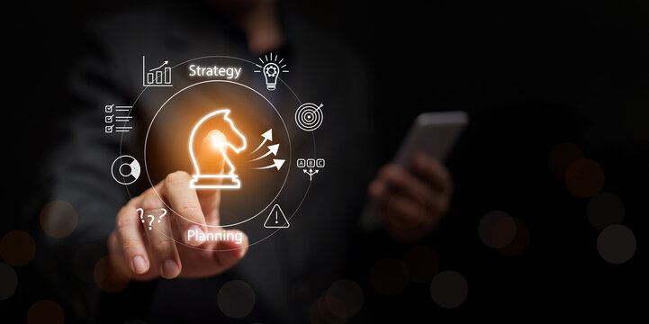 Business strategy and plan concept. Businessman with smartphone point at chess Knight with strategies. Strategic planning, decision making competitive advantage, problem solving, leadership management