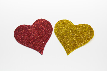 Obraz premium Pair of Glitter Hearts on White Background