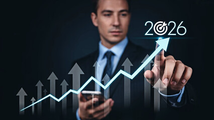 Professional businessman in suit pointing 2026 business growth, financial success, market forecast, and strategic planning on dark background with glowing blue chart success forecast.