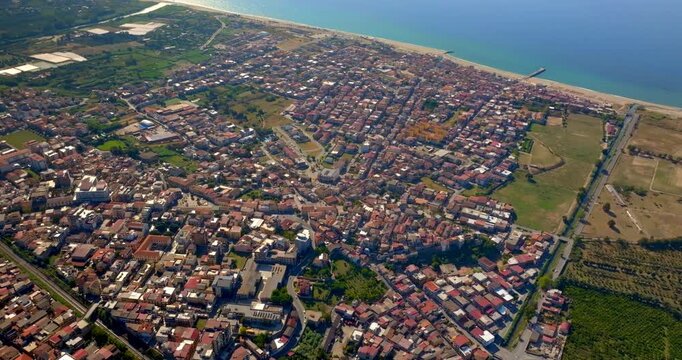 Aerial view of the town of Gioia Tauro, located in the province of Reggio Calabria, Italy. It is a Calabrian city located near the coast overlooking the Tyrrhenian Sea.
