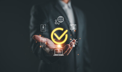 Businessman presenting glowing check mark , representing service quality assurance, performance...