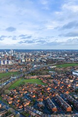 Obraz premium Portrait aerial drone photo of the city centre of Leeds West Yorkshire in the UK showing the British town centre on a cold day in the winter time and rows of houses with the motorway close by