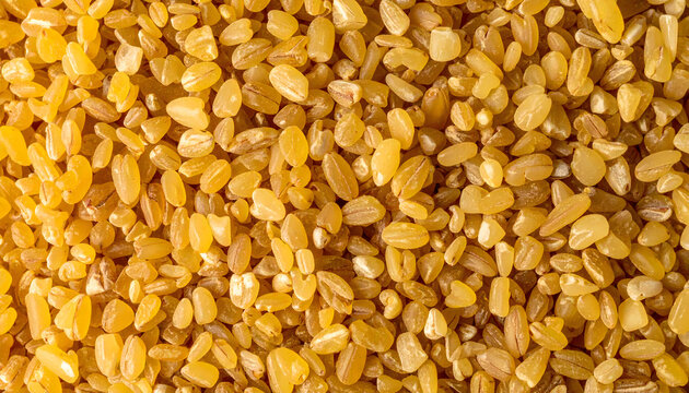Raw bulgur wheat groats texture background top view