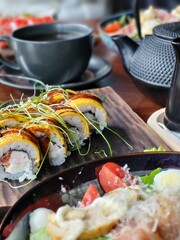 Sushi Rolls With Sauce and Microgreens Close Up