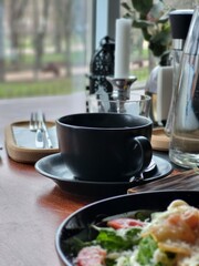 Black Coffee Cup on Cafe Table Close Up