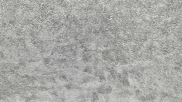gray shag carpet closeup texture plush fuzzy fibers wavy patterns neutral cozy vibe home interior surface detail