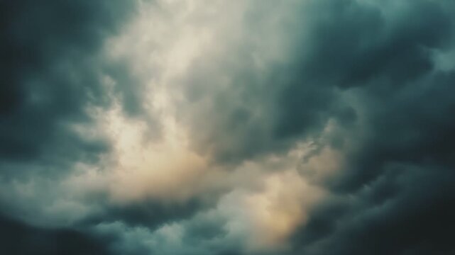Dark storm clouds sweep across the sky, creating a moody, dramatic cloudscape with dense overcast and shafts of light piercing the turbulent, powerful atmosphere