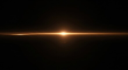 Bright golden lens flare and light streak on dark black background