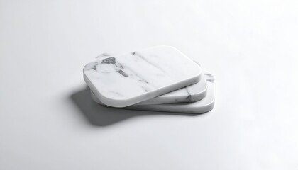 Three square white marble coasters stacked on a white surface