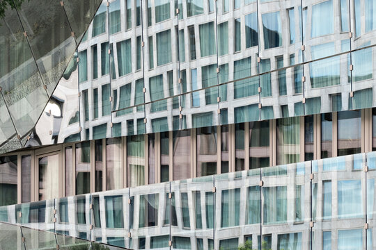 Abstract architecture glass facade with urban reflection pattern on modern building windows forming mosaic grid background texture