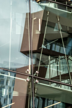 Abstract architecture glass facade with urban reflection pattern on modern building windows showing structural detail and geometric background texture