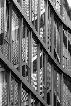 Abstract architecture glass facade with urban reflection pattern on modern building windows in monochrome creating graphic background texture