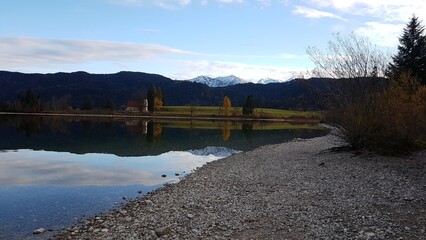Lake Walchensee in Bavaria showcased across all four seasons in an alpine mountain setting.