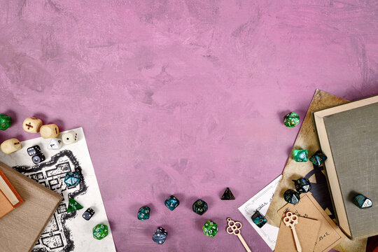 Tabletop role playing flat lay with colorful RPG dices, rule books, dungeon map on purple background with copy space