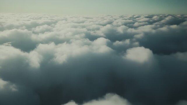 Vast, fluffy cloud layer stretching to the horizon beneath a clear blue sky, evoking serene, peaceful freedom and airy openness ideal for travel, nature, and background use