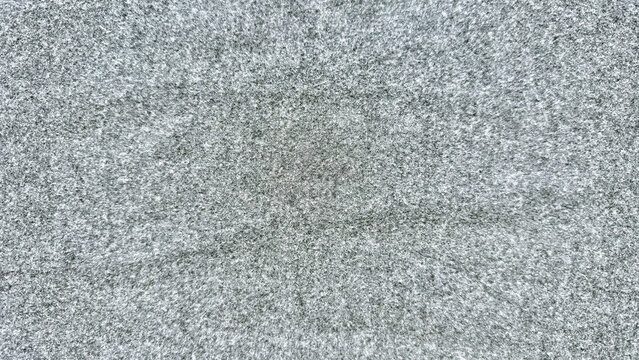 closeup of vintage television static noise on gray screen abstract speckled texture pattern for digital background