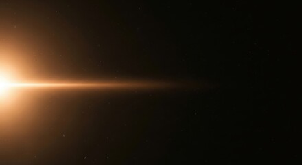 Bright golden lens flare creates horizontal light beam on left of frame against a dark background with subtle dust particles