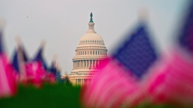 USA federal government. Capitol with waving American flag. United States national symbol Capitol building. American flag and Capitol architecture. USA political power at Capitol Hill.