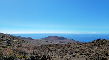 Fototapeta premium Volcanic landscape overlooking volcanic crater and Atlantic Ocean, Island El Hierro, Canary Islands, Spain, Europe.