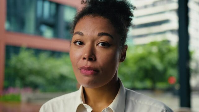 Sad upset African American business woman female girl showing brain explosion overwhelmed businesswoman brainstorm difficulty looking at camera in downtown lady head boom gesture overload overworked