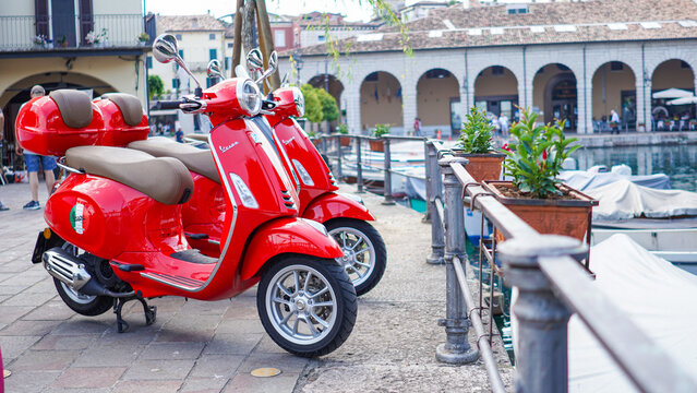 new red Vescpa scooter Piaggio, lake side Piazza malvezzi, 2019 June Desenzano del Garda Italy