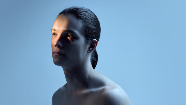 Male portrait in soft blue studio light on clean background. Concept of aesthetic clinic branding, skincare education materials, dermatology presentations, and modern wellness communication.