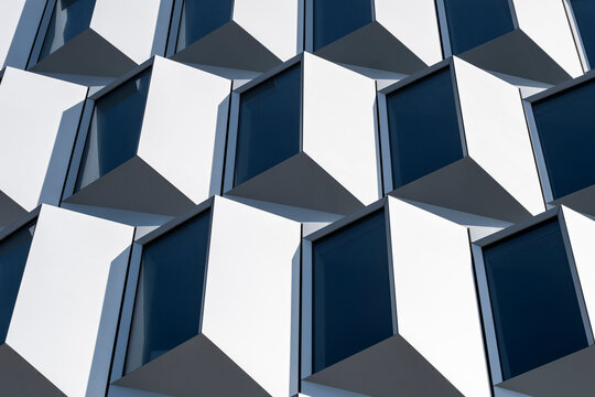 Modern architecture facade with abstract geometry pattern of cubes where shadows and repetition add depth and crisp texture for design concepts
