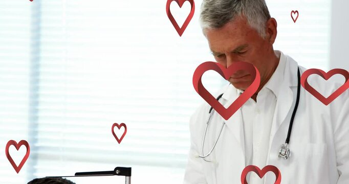 Animation of red pattern over caucasian male doctor using tablet