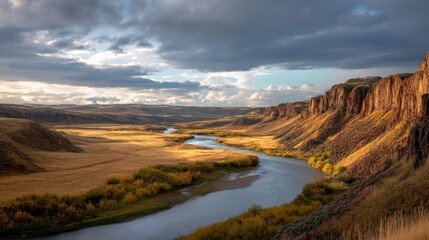 Fototapeta premium River winding through a high desert canyon with dramatic skies. Stunning natural landscape for travel and nature concepts.
