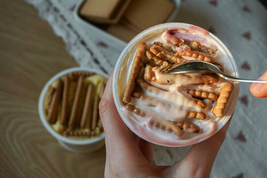 Trendy viral Japanese yogurt cheesecake with cookies biscuit. Preparation of tasty no bake dessert treat at home