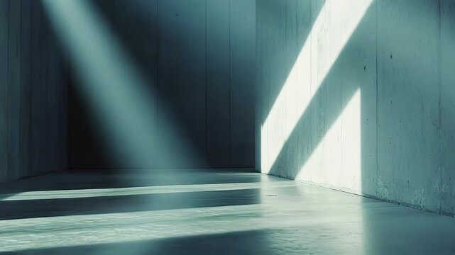 Concrete walls and floor form an empty minimalist interior where strong geometric sunlight cuts across surfaces, casting long dramatic shadows and bold abstract patterns