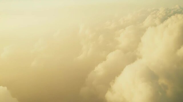 Vast golden cloudscape at sunrise or sunset, soft cumulus layers and warm light evoking tranquil, dreamlike freedom, travel and expansive natural beauty above the horizon