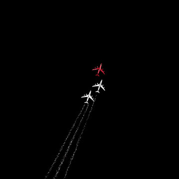 Three airplanes flying against black backdrop aerial view
