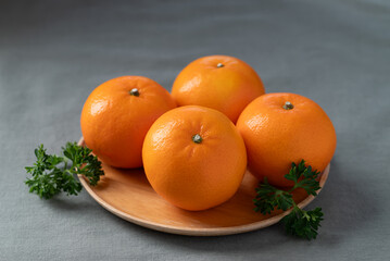 Mandarin tangerine orange fruit on wooden plate