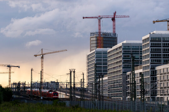 train railway berlin germany cranes construction skyline urban transport at sunset with warm evening light over tracks and city horizon