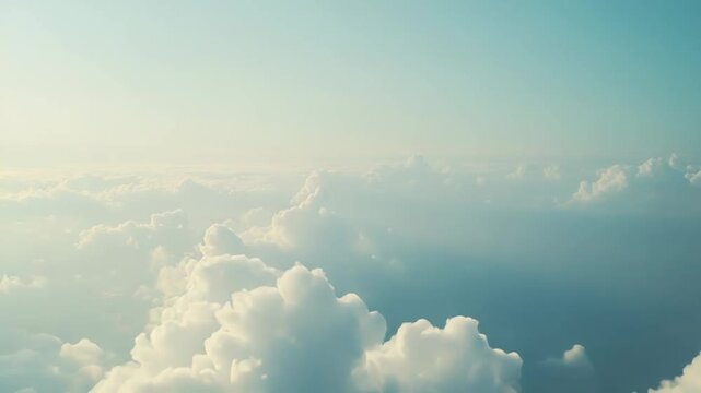 Clouds drifting high above the earth form a soft, endless blue cloudscape serene, airy and peaceful, evoking freedom, travel, spirituality and open sky vistas