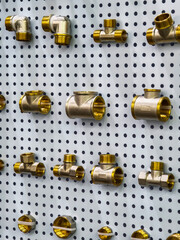 Pipes and fittings display on a wall for plumbing supplies and tools in a hardware store