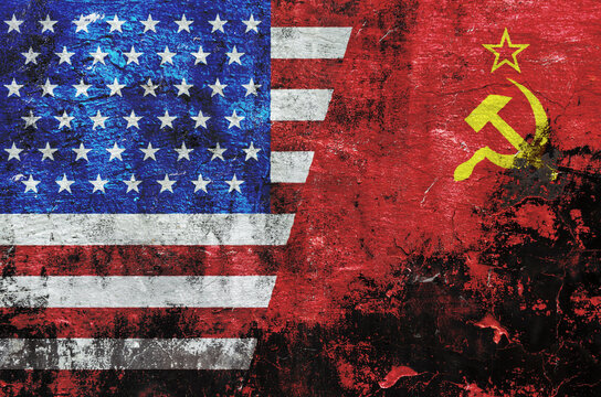flag of the United States of America and the flag of the Soviet Union are painted on an old stone wall