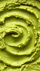 Fototapeta premium Green avocado guacamole dip texture swirl macro top view