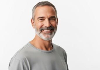 Obraz premium Smiling middleaged man with gray beard and short hair wearing a gray tshirt isolated on white background