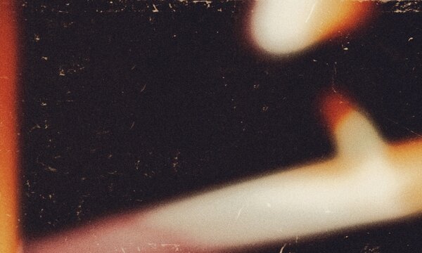 Noisy light leaks photo overlay effect background, grainy dust scratches damaged film photo overlay effect backdrop. Abstract glowing light leaks and film burn effect.