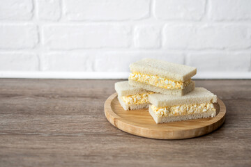 Tamago Sando sandwich on wooden table. Copy space