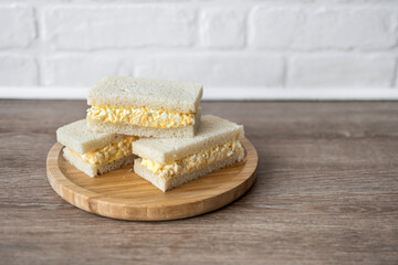 Tamago Sando sandwich on wooden table. Copy space