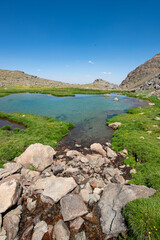 Waterfalls at the Sat Glacier Lakes. Lake landscapes in bloom in spring. Hakkari Cilo Sat Lakes. A lake view in the mountains. Hakkari Cilo Sat Glacier Lakes, mountains covered with flowers.Long expos