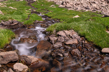 Waterfalls at the Sat Glacier Lakes. Lake landscapes in bloom in spring. Hakkari Cilo Sat Lakes. A lake view in the mountains. Hakkari Cilo Sat Glacier Lakes, mountains covered with flowers.Long expos