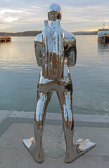 Fototapeta premium Silver Statue of Diver at Dock in Oslo Norway Autumn Afternoon