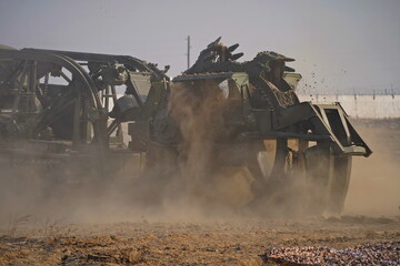 Fototapeta premium Military special equipment digs a trench in a field. Military exercises.