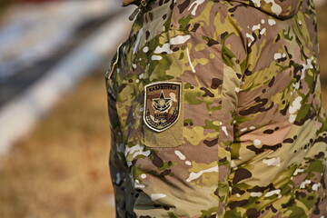 Naklejka premium Almaty, Kazakhstan - 01.20.2026 : A patch on a military uniform. The inscription in Kazakh: the armed forces of the Republic of Kazakhstan.