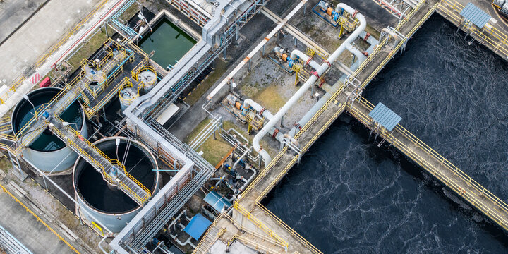Aerial View of Industrial Wastewater Treatment Plant Infrastructure with Aeration Tanks, Clarifiers, and Complex Piping System